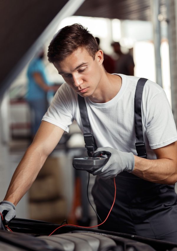 an-attractive-car-mechanic-is-checking-the-results-of-his-work-at-a-car-repair-service.jpg